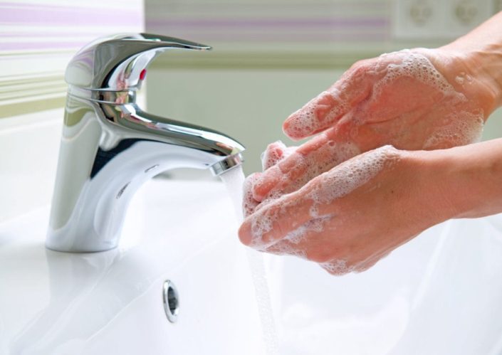 Person washing their hands in a sink