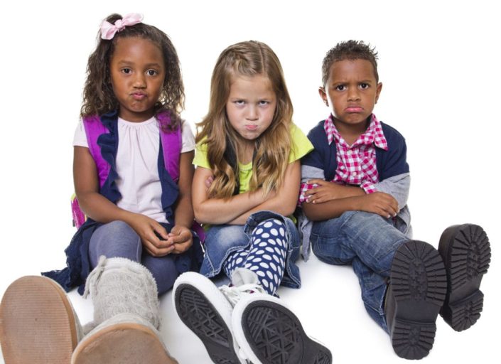 Group of three angry or upset children