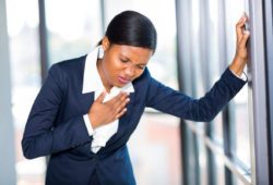 young African American businesswoman having chest pain