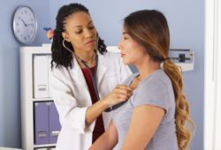 A doctor listens to a patient’s lungs with a stethoscope. Pneumonia is an infection of the lungs usually caused by bacteria or a virus. Walking pneumonia is a mild case of pneumonia.