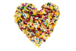 Colorful tablets and capsules arranged in heart shape to represent medicine for heart problems