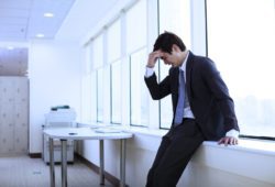 A young businessman having a panic attack in an office. Panic disorder is a condition in which a person has sudden episodes of intense fear or anxiety. These episodes are known as panic attacks.