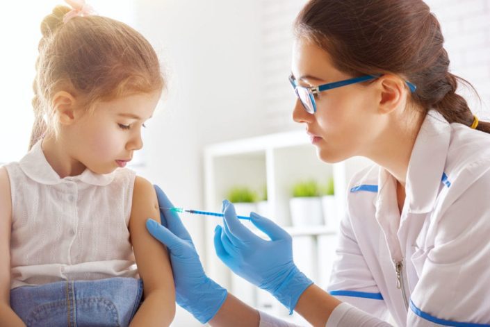 doctor gives achickenpox vaccination to a young girl