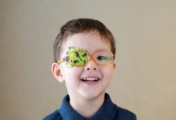 young boy with adhesive eye patch over his eye