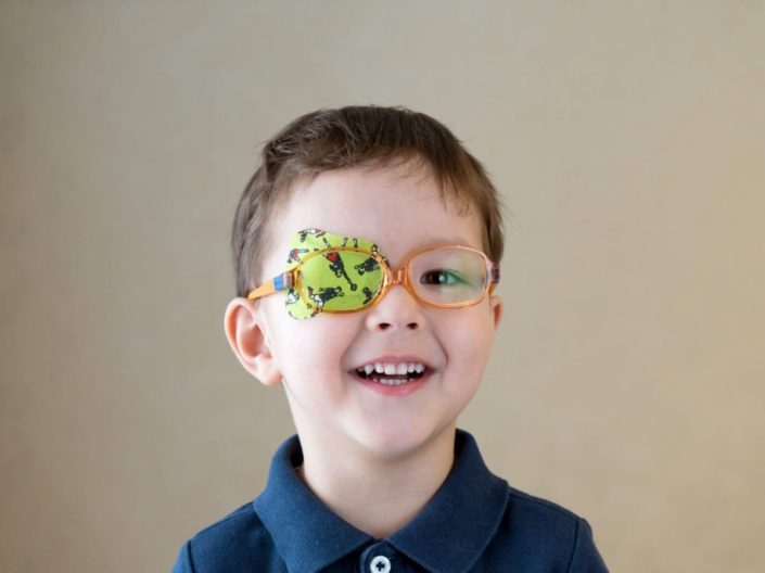 young boy with adhesive eye patch over his eye