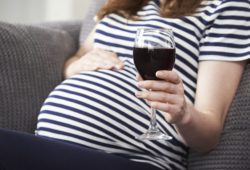 Close Up Of Pregnant Woman Drinking Red Wine