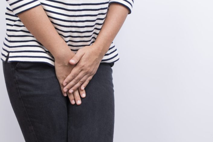 Woman with hands crossed over her pelvis as if she is in pain or needs to use the restroom. Interstitial cystitis is chronic inflammation of the bladder. This inflammation can scar the bladder or make it stiff.