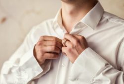 businessman buttoning his shirt