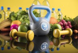 hand weights, water bottles and fresh fruit and vegetables