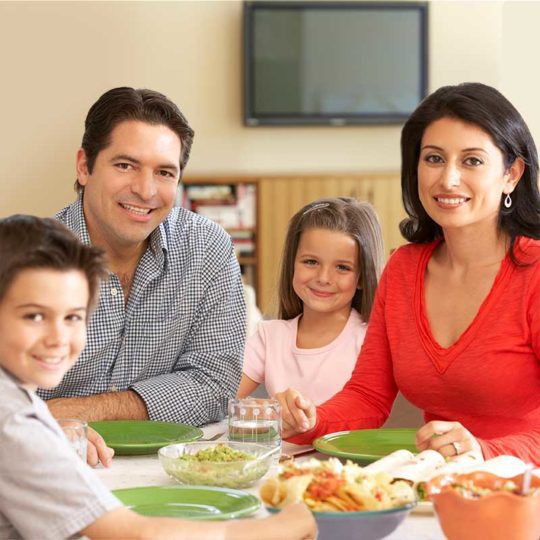 family eating dinner and watching their cholesterol