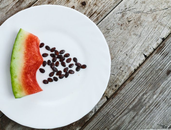 Eaten watermelon slice and seeds on a plate