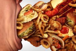 Person’s mouth consuming fast food, junk food, and baked goods, which contain bad trans fats.