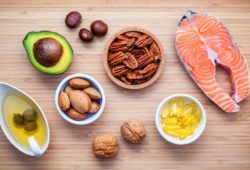 Assortment of foods high in omega-3s and unsaturated fats. Fat should be part of your diet. Your body uses for good fats energy and other health benefits, but bad fats lead to serious health problems.