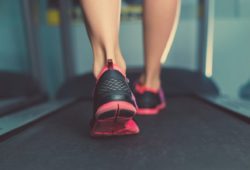 A close-up of feet walking on a treadmill
